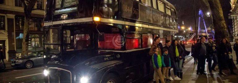 Ghost Tour Bus with people standing outside at night