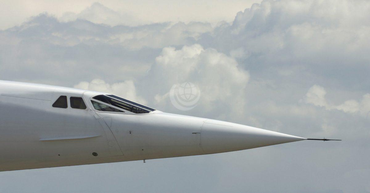 Concorde flying in sky with zoom in on droop nose