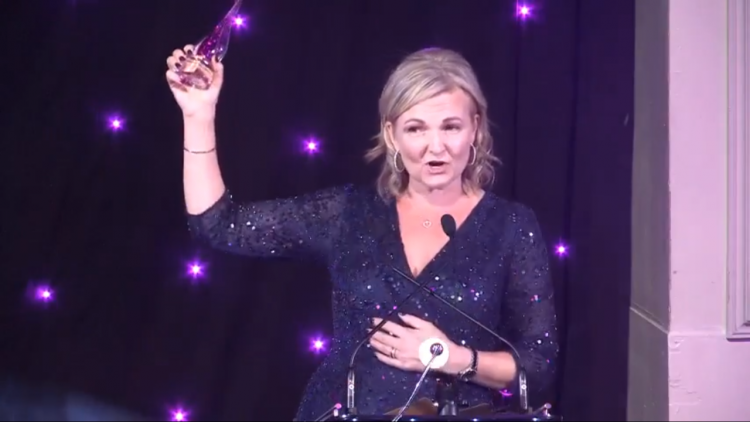Helen Tonks Winner of Enterprise Vision Awards Internet Industry Award holding her trophy