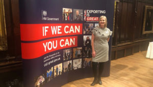 Helen Tonks, Hydraulics Online, in front of Export Champion sign