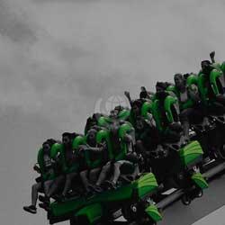 Green roller coaster with screaming people