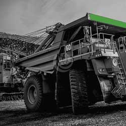 Green mining vehicle outside quarry