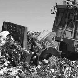 Waste compactor on landfill site