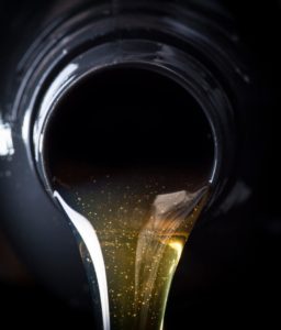 Hydraulic oil pouring from a bottle